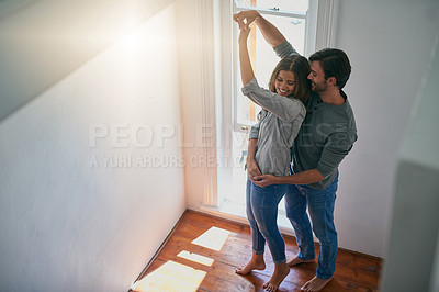 Buy stock photo Shot of an affectionate young couple getting ready to dance