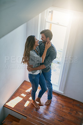 Buy stock photo Shot of an affectionate young couple starring into each others eyes