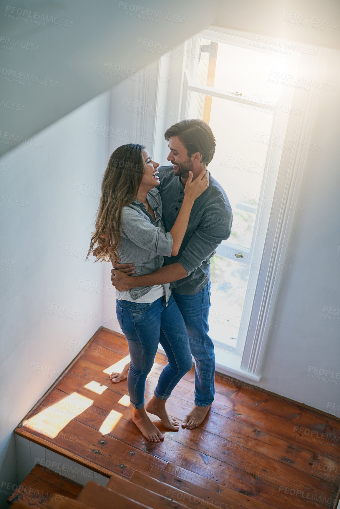 Buy stock photo Shot of an affectionate young couple starring into each others eyes