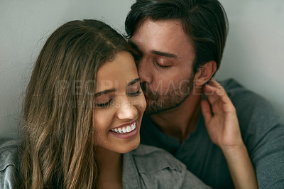 Buy stock photo Shot of an affectionate young couple sharing a moment together