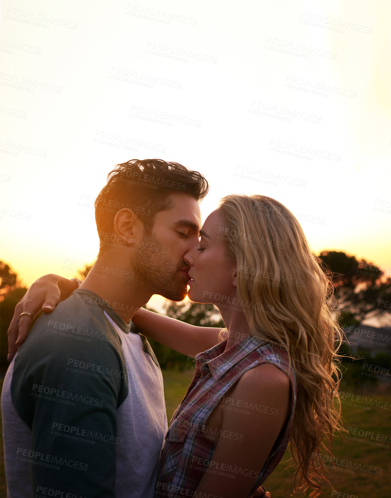 Buy stock photo Cropped shot of an affectionate young couple outdoors