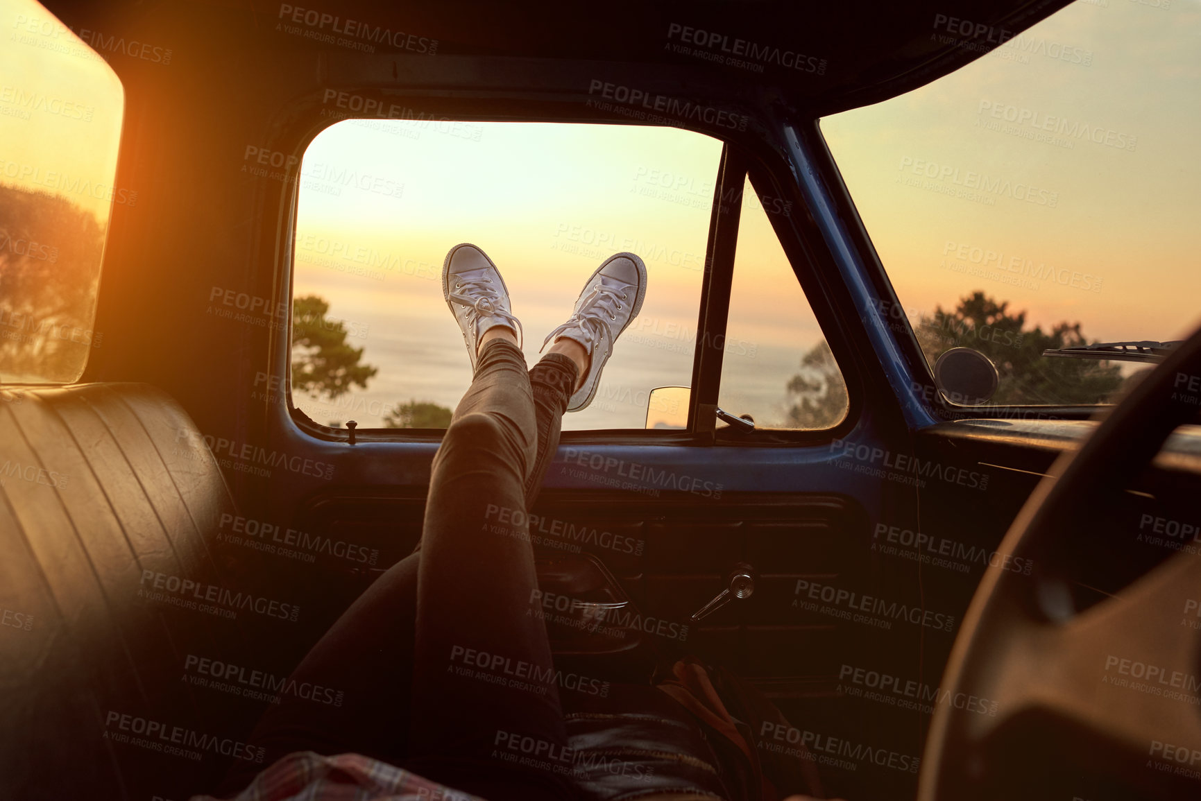 Buy stock photo Cropped shot of an unrecognizable woman lying in a car during a roadtrip