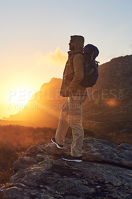 Buy stock photo Shot of a hiker on top of a mountain taking in the views of the morning sun