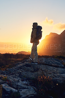 Buy stock photo Shot of a hiker on top of a mountain looking at the view