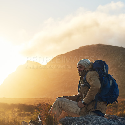 Buy stock photo Shot of a hiker sitting on top of a mountain smiling