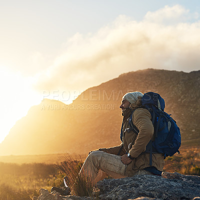 Buy stock photo Shot of a hiker siting on top of a mountain smiling and enjoying the views