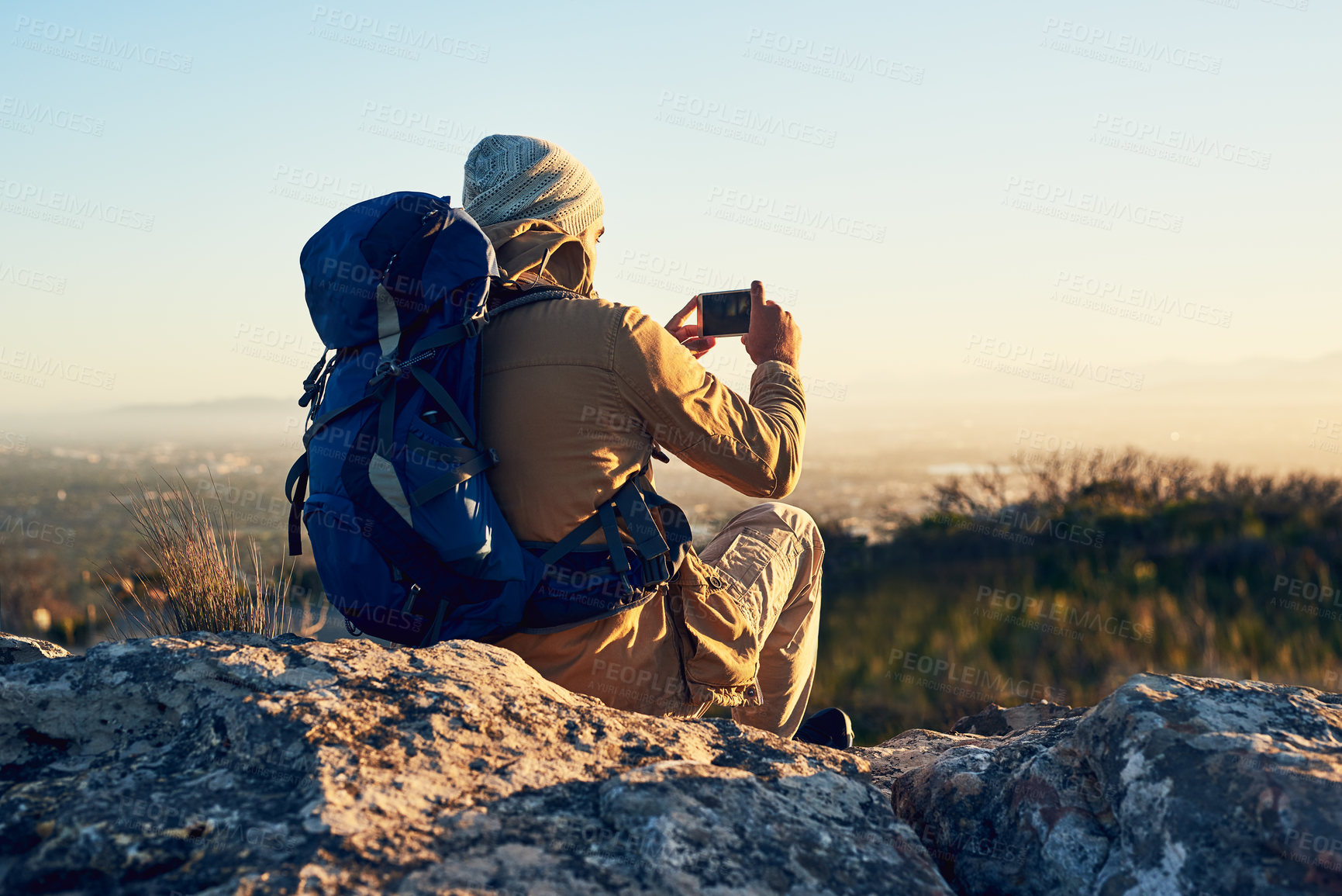 Buy stock photo Back, hiking and photograph with man in mountains for break, memory or scenic view of nature. Earth, phone camera and rest in summer with hiker person outdoor for adventure, fresh air or journey