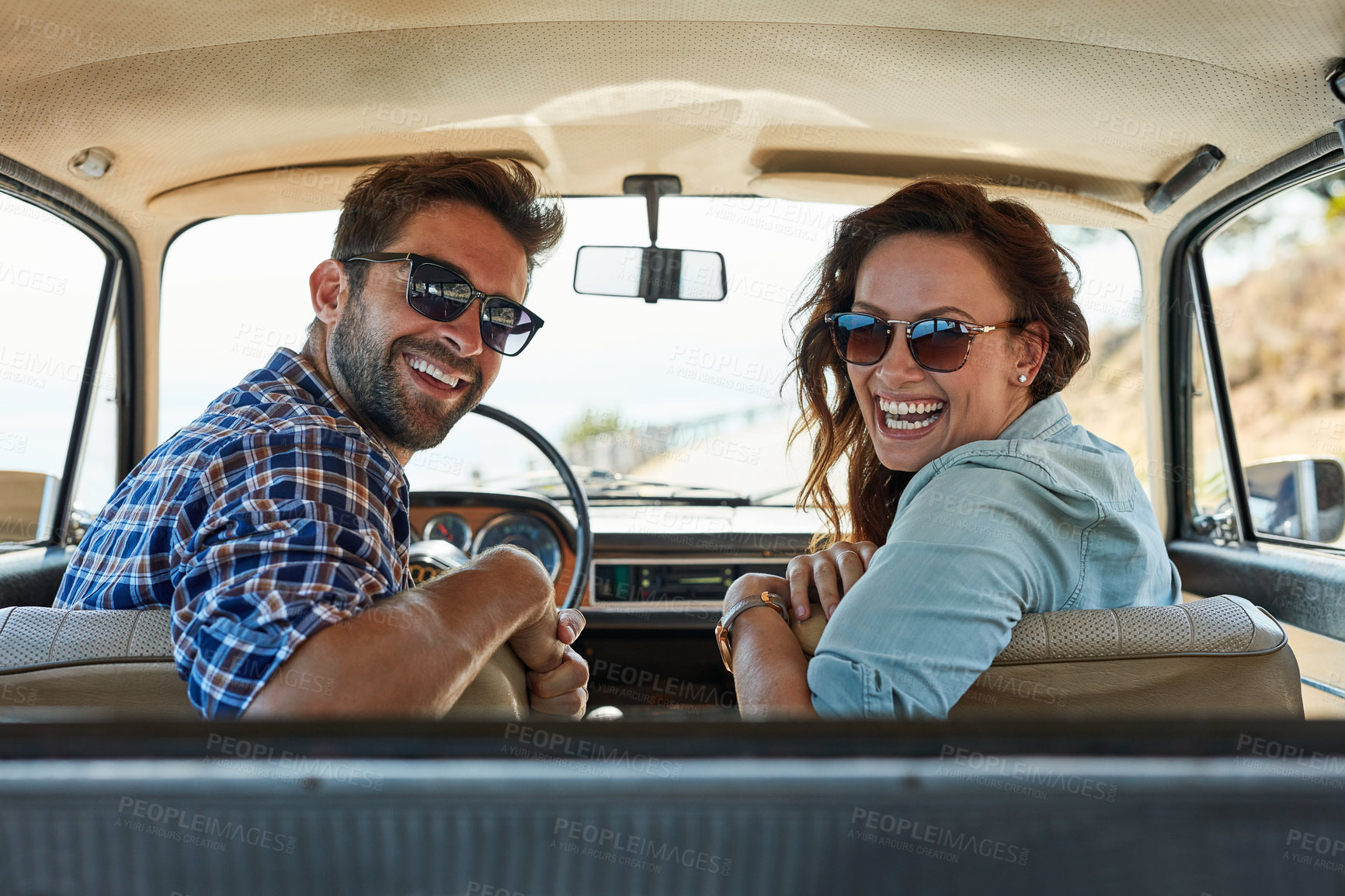 Buy stock photo Rearview portrait of an affectionate couple enjoying a summer road trip