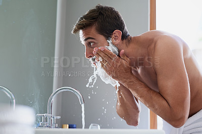 Buy stock photo Cropped shot of a handsome young man in his bathroom