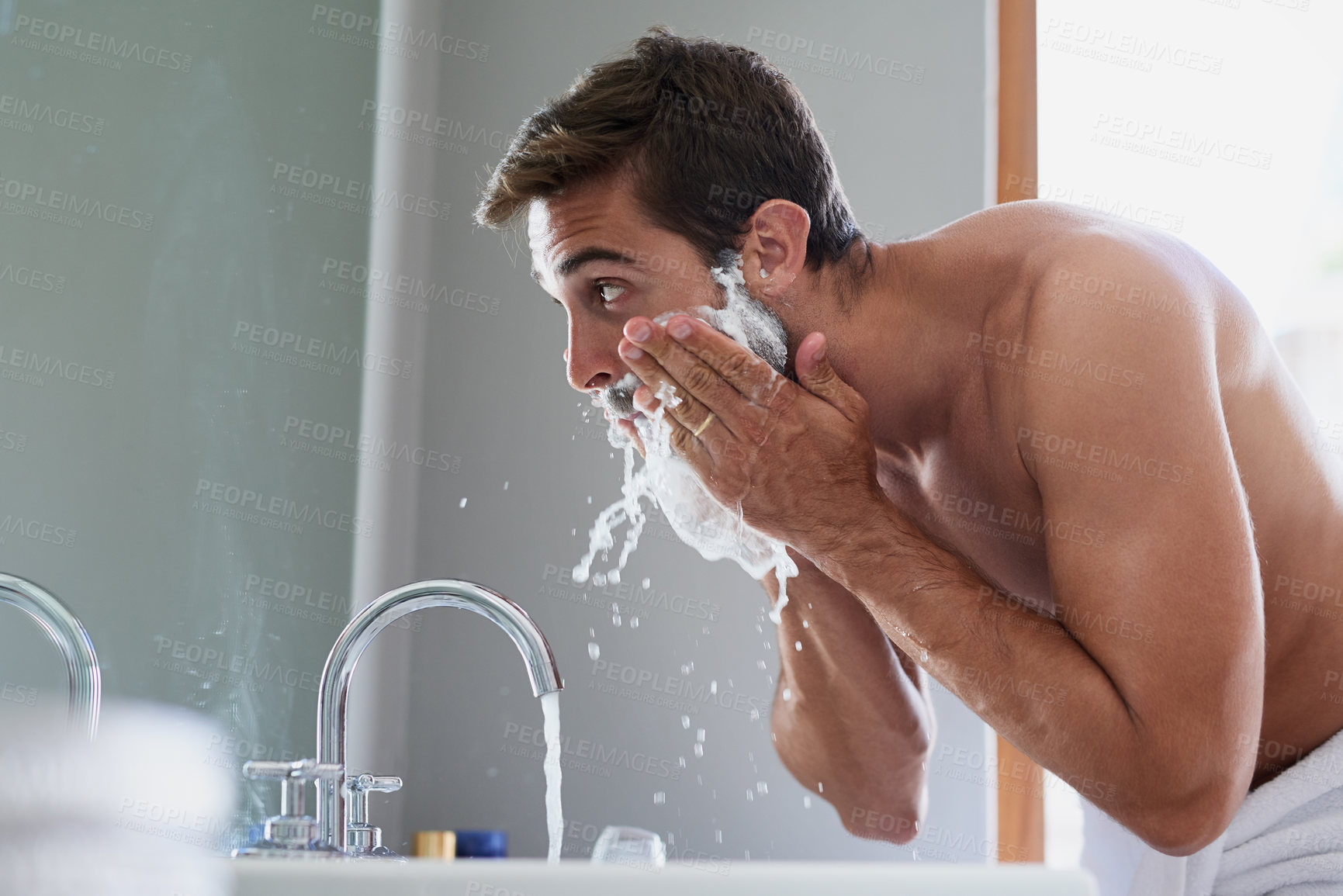 Buy stock photo Cropped shot of a handsome young man in his bathroom
