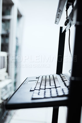 Buy stock photo Cropped shot of a computer monitor and keyboard inside of a IT server room