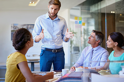 Buy stock photo Cropped shot of a group of businesspeople having a meeting in the office