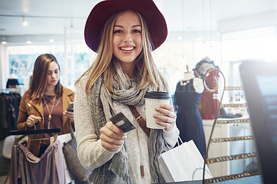 Buy stock photo Shot of a young woman ready to pay for her goods in a clothing store