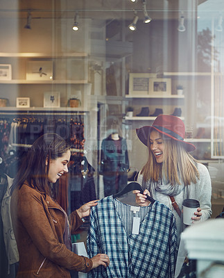 Buy stock photo Shot of two best friends out shopping in a clothing store