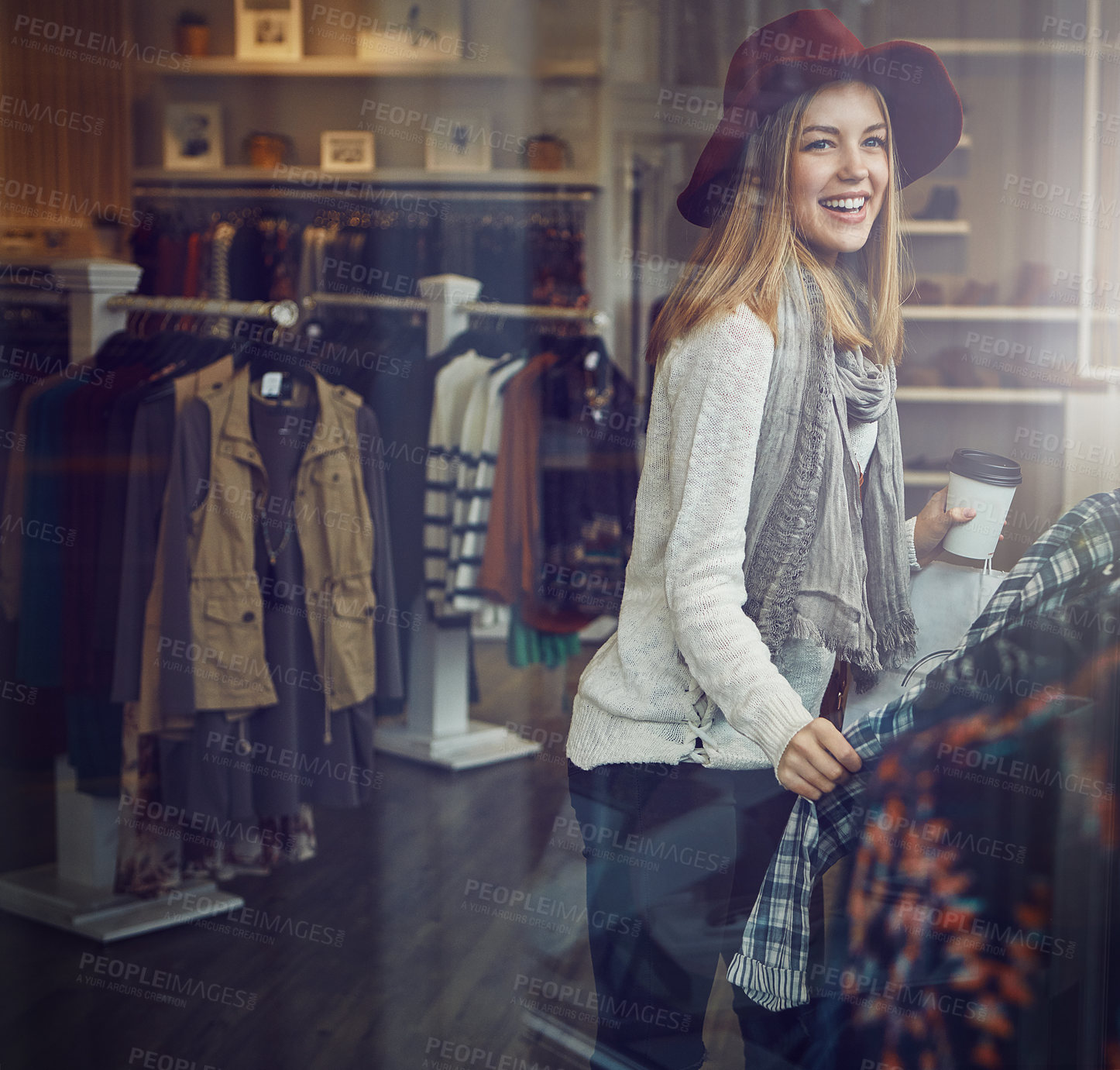 Buy stock photo Shot of a young woman shopping at a clothing store