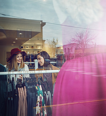 Buy stock photo Shot of two best friends out shopping in a clothing store