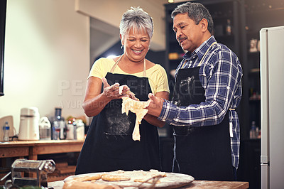 Buy stock photo Cooking, love and senior couple in kitchen at home with dough, flour and ingredients for meal. Happy, food and elderly man and woman preparing dinner, lunch or supper together at house in Mexico.