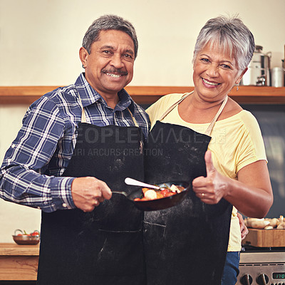 Buy stock photo Shot of a mature couple cooking together at home