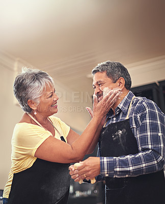 Buy stock photo Senior, couple and flour in kitchen, fun and bonding in home, morning and pancakes for breakfast. Happiness, old man and woman in house, marriage and love with care, cooking and together for food