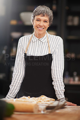 Buy stock photo Shot of a mature woman cooking at home