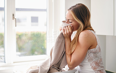 Buy stock photo Woman, smelling laundry and clothes in basket with happiness for clean clothes in living room. Female person, cleaning and fabric for housework or lifestyle of enjoyment in apartment at home.