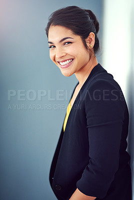 Buy stock photo Studio portrait of an attractive young businesswoman standing against a blue background