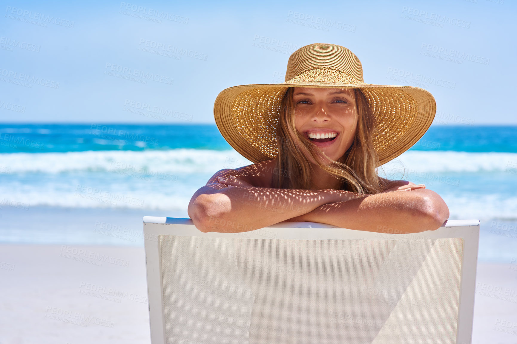 Buy stock photo Portrait, beach and woman with a smile, holiday and summer getaway with tourism, break or travelling. Face, female person or girl on a chair, seaside vacation or travel with a hat or relax with waves