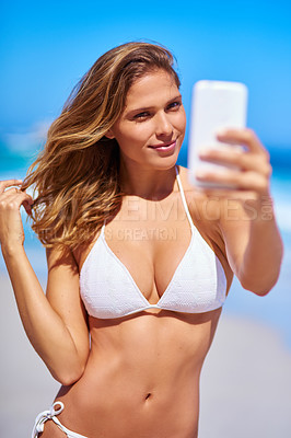 Buy stock photo Shot of an attractive young woman enjoying a vacation at the beach