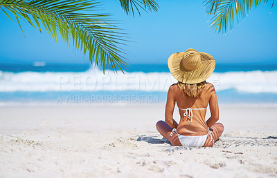 Buy stock photo Relax, back view of a woman on the beach and sitting on the sand, Summer vacation or holiday break, freedom or adventure and female person relaxing at the sea with blue sky for peace in nature