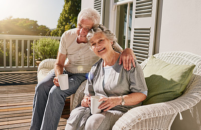 Buy stock photo Hug, patio and portrait of senior couple with coffee enjoying bonding, quality time and relax in morning. Love, retirement and elderly man and woman embrace with drink for breakfast outdoors at home