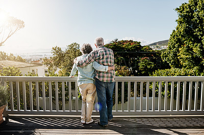 Buy stock photo Rearview shot of a senior couple embracing outside on the balcony