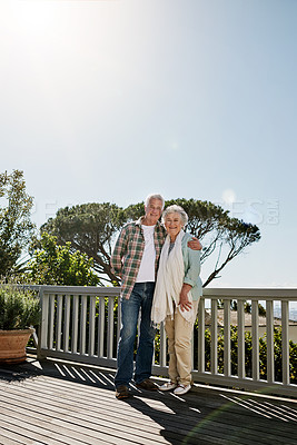 Buy stock photo Shot of a happy senior couple relaxing together on the patio at home