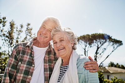 Buy stock photo Shot of a happy senior couple relaxing together outdoors