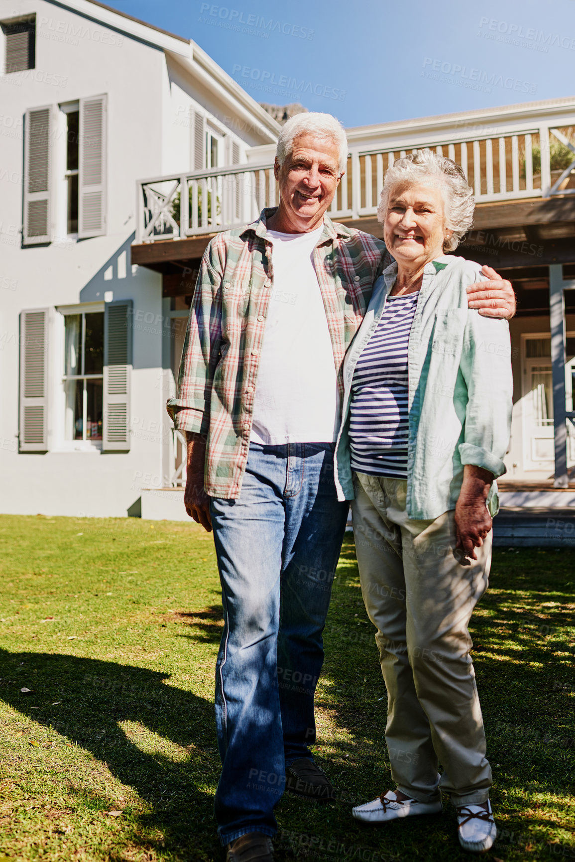Buy stock photo Senior couple, new home and hug on grass or outdoors celebrating property or mortgage together. Elderly, partners and outside house or moving in real estate or security for retired homeowners 