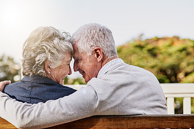 Buy stock photo Senior couple, bonding and hug or relaxing together outdoors or romantic retirement and park bench. Elderly, partners and affectionate or in love or date and feeling care for pension or garden 