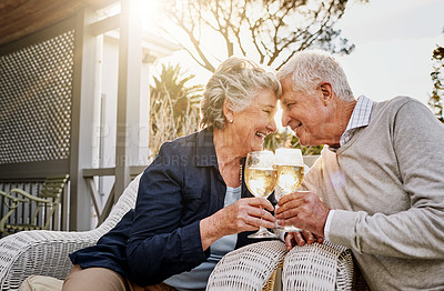 Buy stock photo Love, cheers and wine, old couple celebrate romance or anniversary on patio of vacation home. Happiness, senior man and woman touching heads with champagne toast, smile and romantic date on holiday.