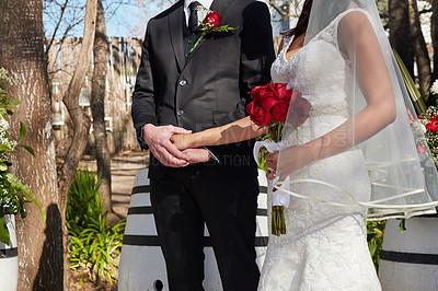 Buy stock photo Cropped shot of a bride and groom at their outdoor wedding ceremony