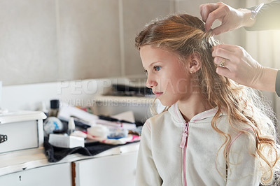 Buy stock photo Shot of a little girl getting her hair done before a celebration event