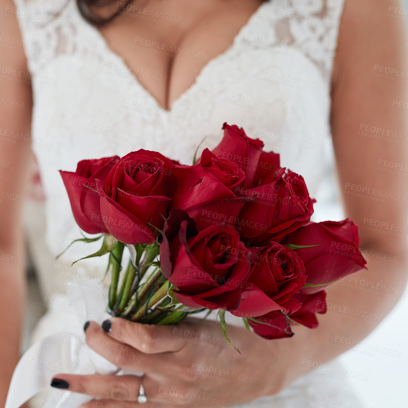 Buy stock photo Cropped closeup of a woman holding red roses on her wedding day
