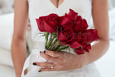 Buy stock photo Cropped closeup of a woman holding red roses on her wedding day