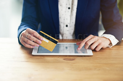 Buy stock photo Cropped shot of an unrecognisable businesswoman making a credit card payment online using a digital tablet