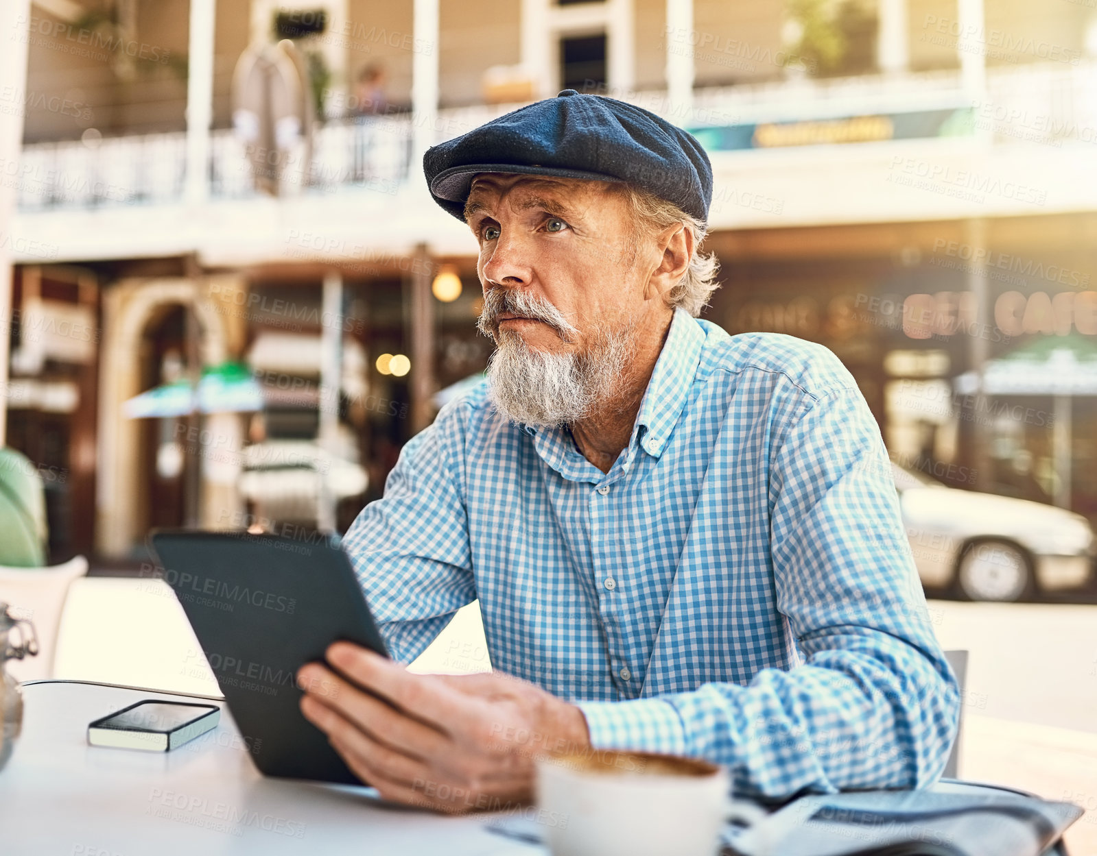 Buy stock photo Coffee shop, table and senior man with tablet in city for online, search and digital news in morning. Thinking, person and communication with tech at restaurant for media, website and review of cafe