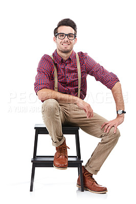 Buy stock photo Nerd, smile and portrait of a man sitting on a chair wearing geek clothing and glasses. White background, happiness and smiling model on a stool in a studio looking positive, smart and hipster