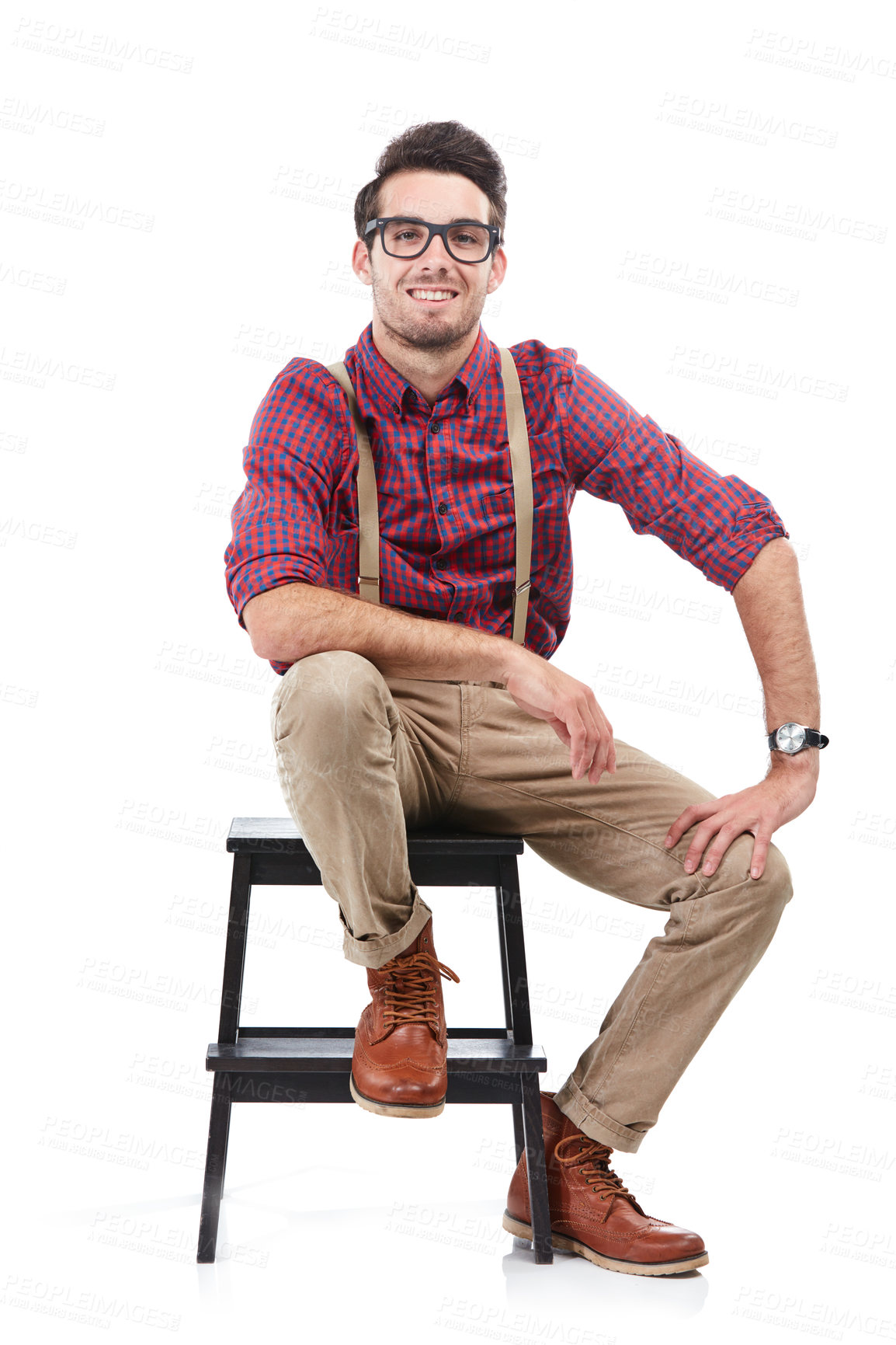 Buy stock photo Nerd, smile and portrait of a man sitting on a chair wearing geek clothing and glasses. White background, happiness and smiling model on a stool in a studio looking positive, smart and hipster