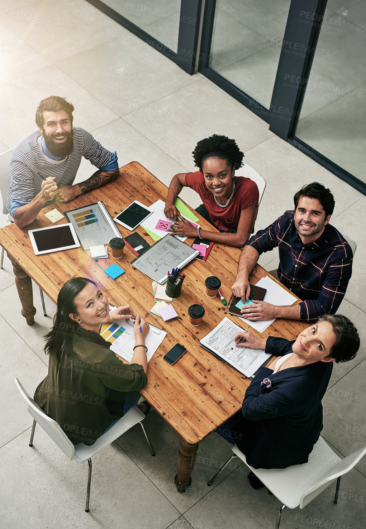 Buy stock photo High angle shot of a group of designers having a meeting in an office