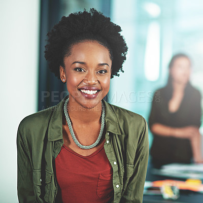 Buy stock photo Portrait of a businesswoman standing in an office with her colleagues in the background