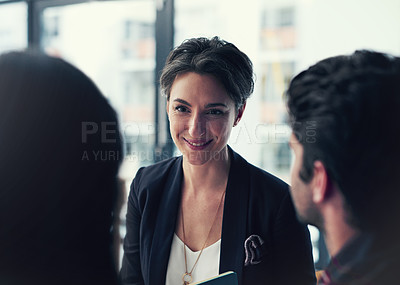 Buy stock photo Shot of a group of colleagues having a discussion in a modern office