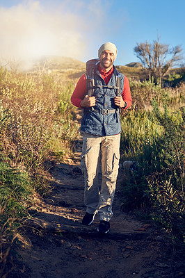 Buy stock photo Portrait of a happy hiker out on a mountain hiking trail on his own