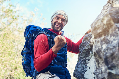 Buy stock photo Portrait of a happy young hiker enjoying a mountain trail on his own