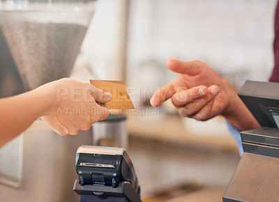 Buy stock photo Shot of an unidentifiable woman making a payment with her credit card in a coffee shop